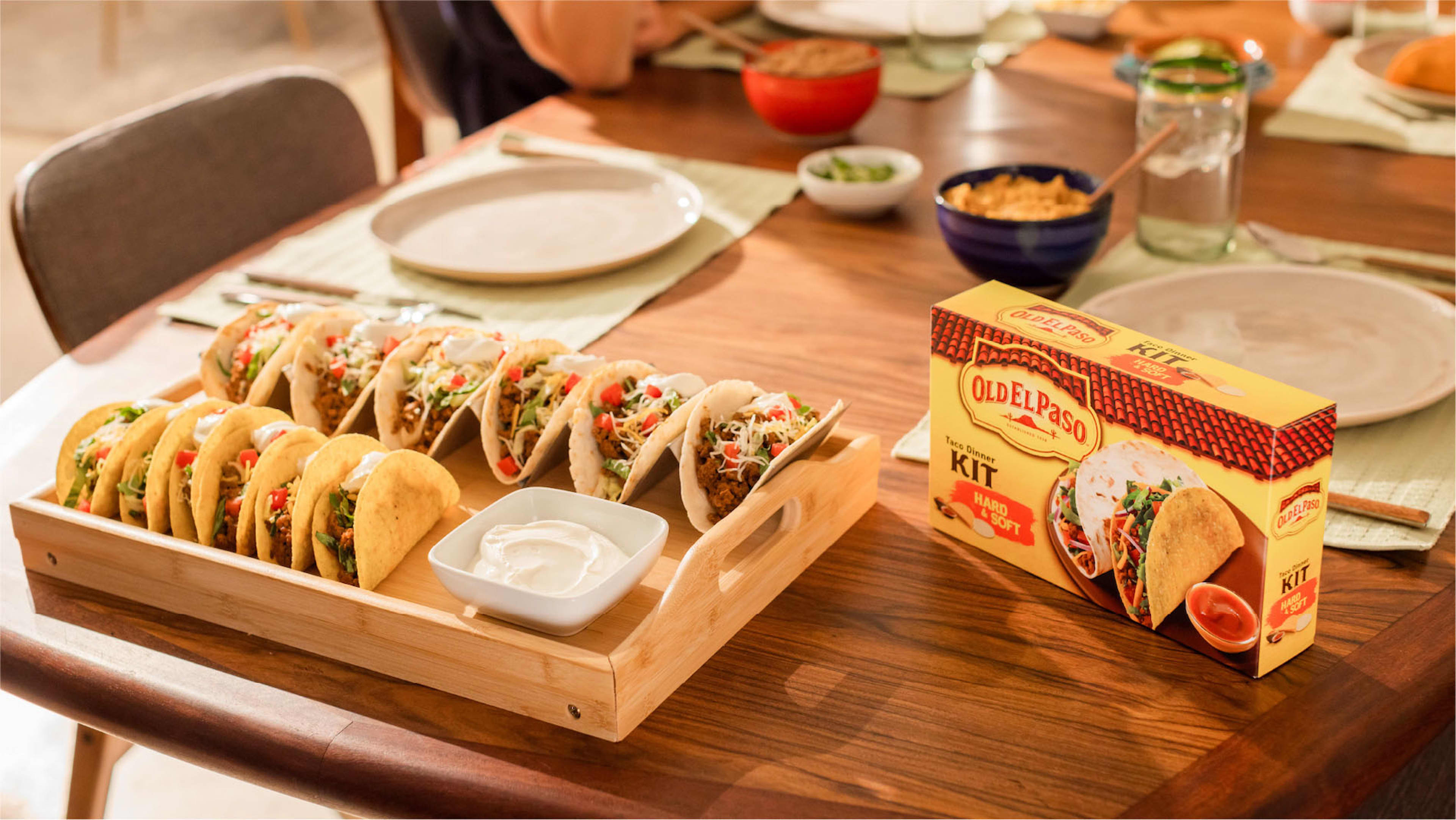 Table with a tray of tacos and a box of Old El Paso taco shells